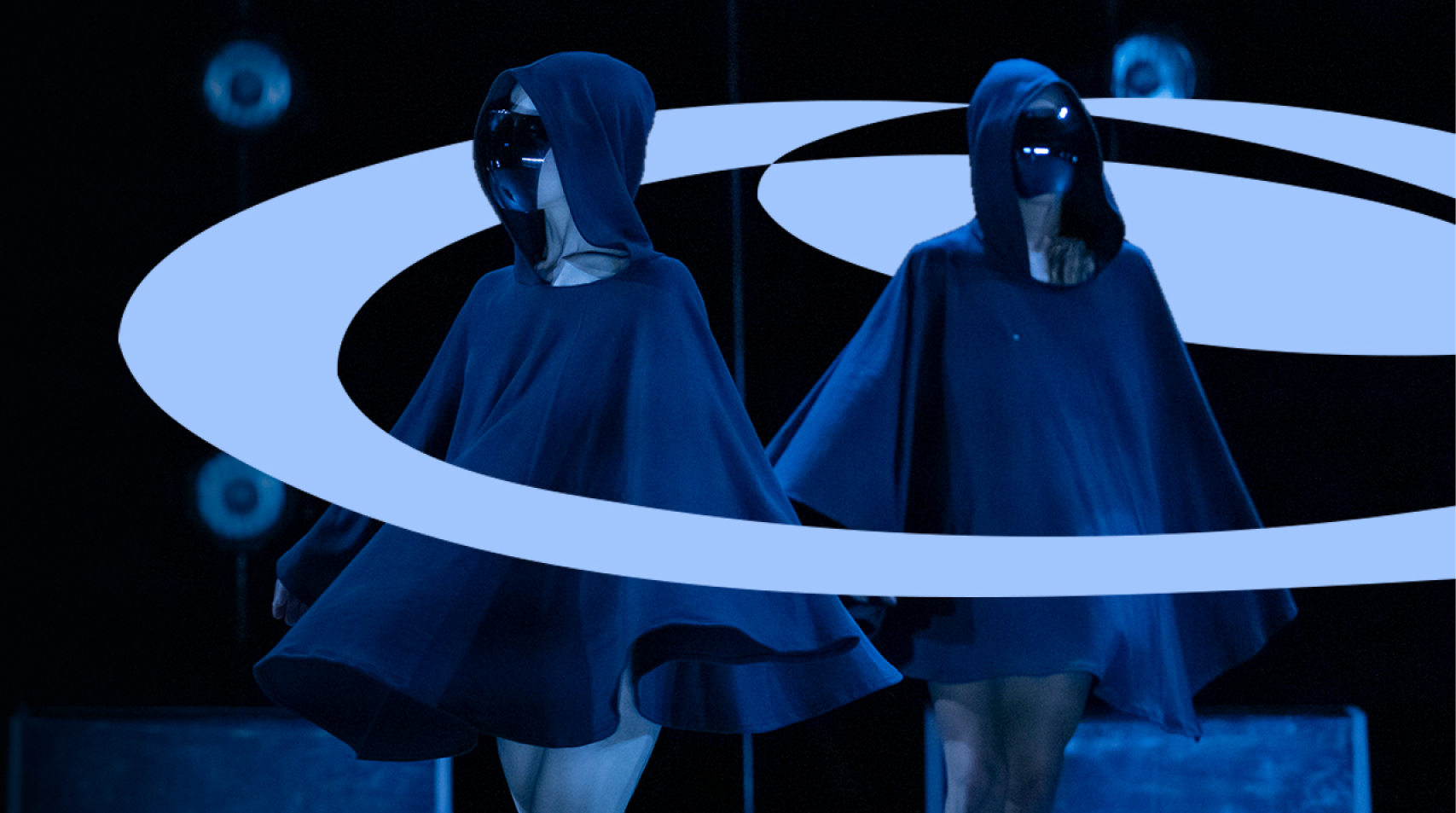 Foto de duas bailarinas com capas e óculos pretos